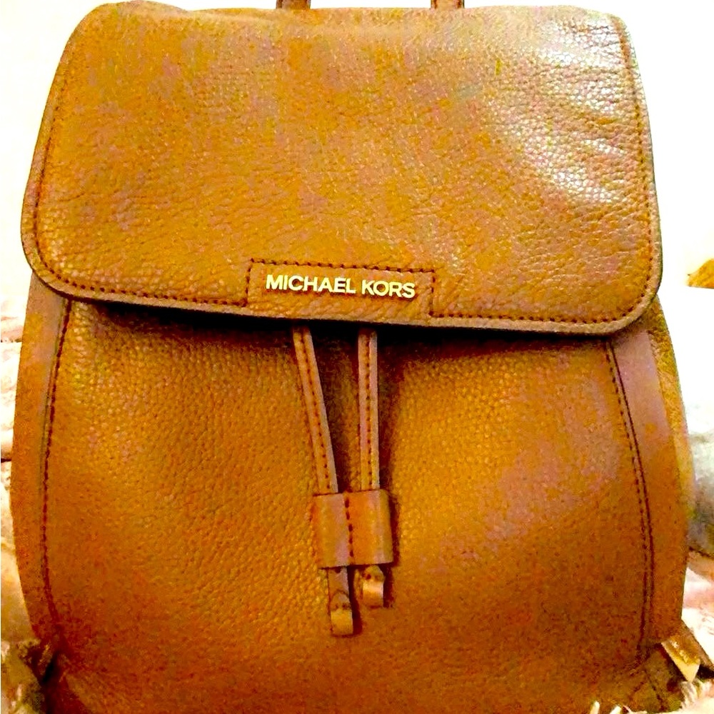 Authentic medium sized Michael Kors tan colored leather backpack purse
